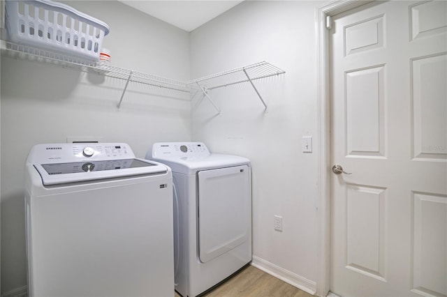 2406 Placid Way, Kissimmee, FL 34758 - washroom featuring separate washer and dryer, light wood finished floors, and baseboards