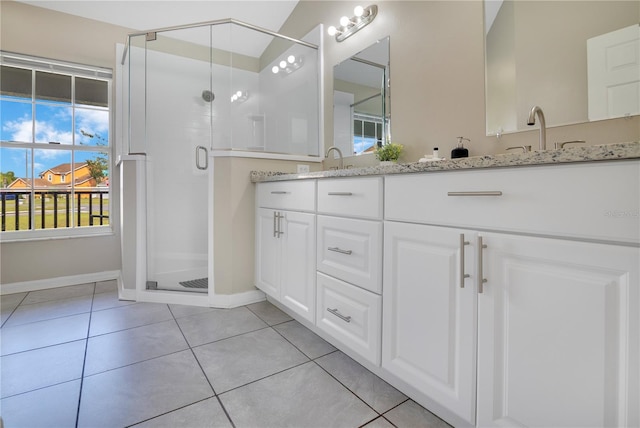 2406 Placid Way, Kissimmee, FL 34758 - bathroom featuring double vanity, a shower stall, tile patterned floors, and baseboards