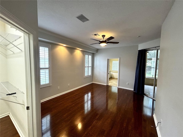 563 Pleasant Grove Dr, Winter Springs, FL 32708 - unfurnished bedroom featuring wood finished floors, multiple windows, baseboards, a textured ceiling, and ensuite bathroom