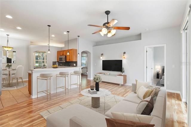 2280 Yorville Ct, Ocoee, FL 34761 - living room with arched walkways, light wood-type flooring, recessed lighting, and ceiling fan