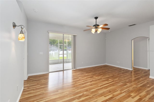 2280 Yorville Ct, Ocoee, FL 34761 - empty room featuring light wood-style floors, ceiling fan, and arched walkways