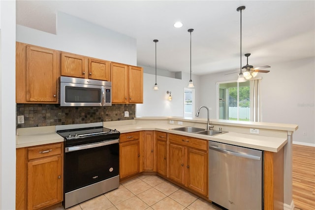 2280 Yorville Ct, Ocoee, FL 34761 - kitchen with stainless steel appliances, a peninsula, tasteful backsplash, and light countertops