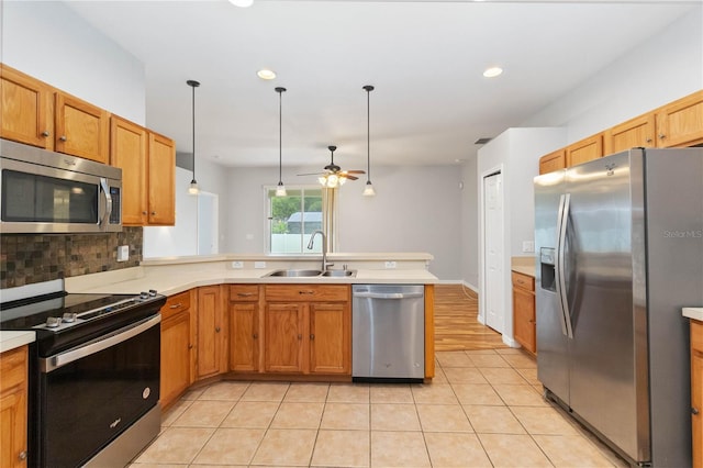 2280 Yorville Ct, Ocoee, FL 34761 - kitchen featuring appliances with stainless steel finishes, a peninsula, ceiling fan, tasteful backsplash, and light countertops