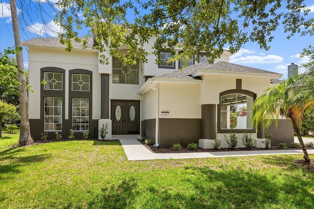 14927 Faversham Cir, Orlando, FL 32826 - mediterranean / spanish-style home with a front yard, stucco siding, and roof with shingles
