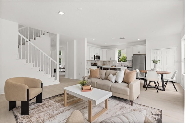 14927 Faversham Cir, Orlando, FL 32826 - living area with stairs, light wood-style flooring, and recessed lighting