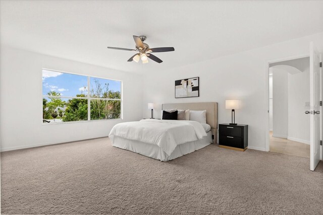 14927 Faversham Cir, Orlando, FL 32826 - bedroom with light colored carpet, baseboards, ceiling fan, and arched walkways