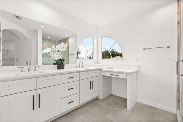 14927 Faversham Cir, Orlando, FL 32826 - bathroom featuring double vanity, a shower stall, and baseboards