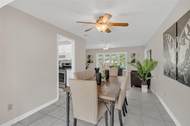 8134 Hook Cir, Orlando, FL 32836 - dining room with a ceiling fan, light tile patterned floors, and baseboards