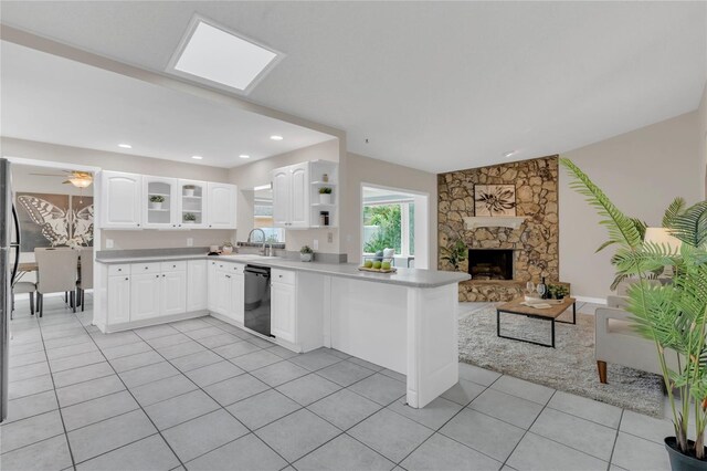 8134 Hook Cir, Orlando, FL 32836 - kitchen featuring black dishwasher, a peninsula, a sink, light tile patterned floors, and open floor plan