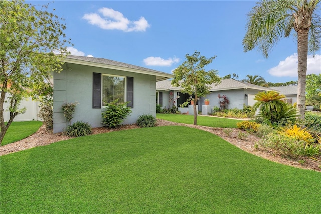 8134 Hook Cir, Orlando, FL 32836 - view of front of home with a front yard, stucco siding, and a shingled roof