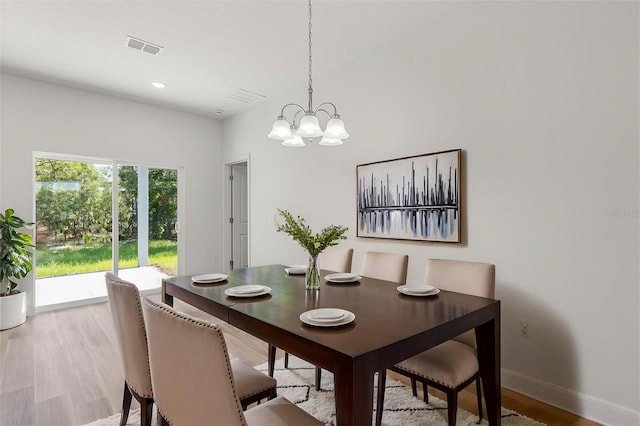 3863 W Galleon St, Dunnellon, FL 34433 - dining room featuring a chandelier, wood finished floors, and baseboards