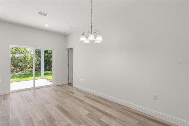 3863 W Galleon St, Dunnellon, FL 34433 - empty room with a chandelier, light wood-style flooring, baseboards, and recessed lighting