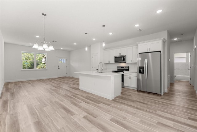 3863 W Galleon St, Dunnellon, FL 34433 - kitchen featuring stainless steel appliances, a sink, recessed lighting, light countertops, and light wood-type flooring