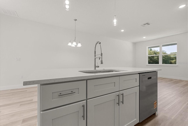 3863 W Galleon St, Dunnellon, FL 34433 - kitchen with a sink, stainless steel dishwasher, light wood-style flooring, pendant lighting, and a center island with sink