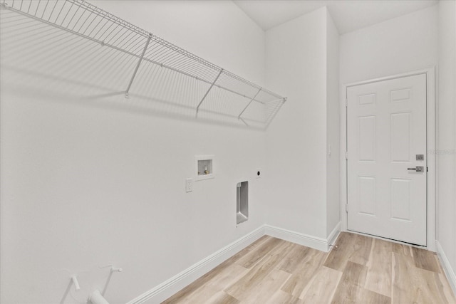 3863 W Galleon St, Dunnellon, FL 34433 - washroom with light wood-style floors, baseboards, hookup for an electric dryer, and washer hookup