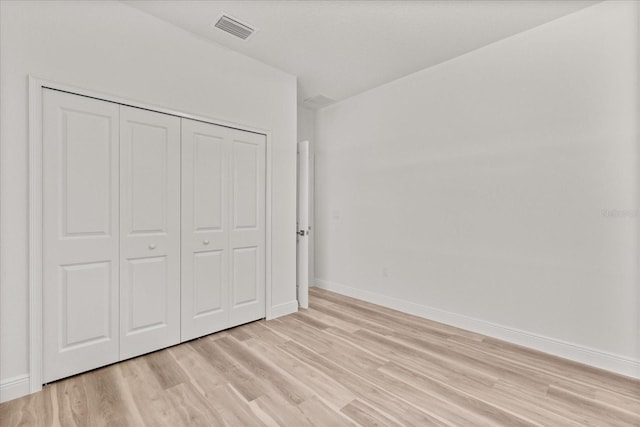3863 W Galleon St, Dunnellon, FL 34433 - unfurnished bedroom featuring light wood finished floors, baseboards, and a closet
