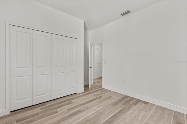 3863 W Galleon St, Dunnellon, FL 34433 - unfurnished bedroom with light wood-style floors, baseboards, and a closet