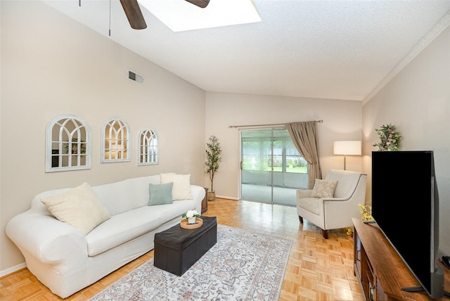 3033 Dunhill Dr, Cocoa, FL 32926 - living room with lofted ceiling, a ceiling fan, a skylight, a textured ceiling, and baseboards