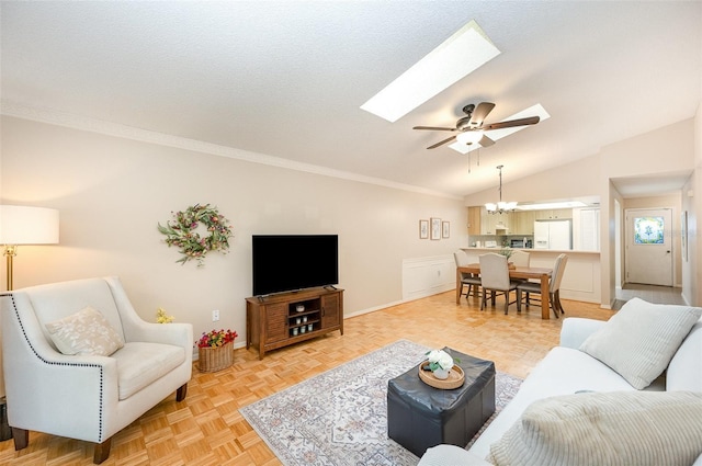3033 Dunhill Dr, Cocoa, FL 32926 - living room with a chandelier, a skylight, vaulted ceiling, a ceiling fan, and baseboards