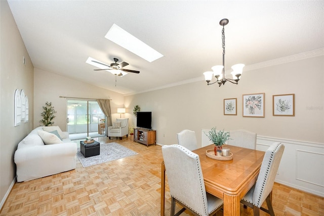 3033 Dunhill Dr, Cocoa, FL 32926 - dining room with a skylight, ceiling fan, a chandelier, vaulted ceiling, and baseboards