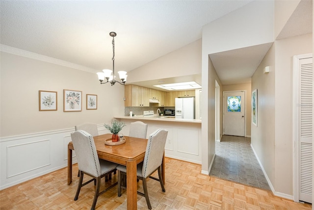 3033 Dunhill Dr, Cocoa, FL 32926 - dining space featuring a chandelier, lofted ceiling, and baseboards