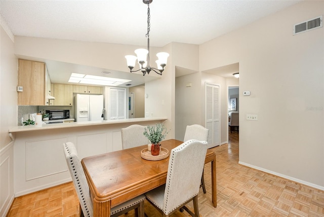 3033 Dunhill Dr, Cocoa, FL 32926 - dining area with a chandelier and baseboards