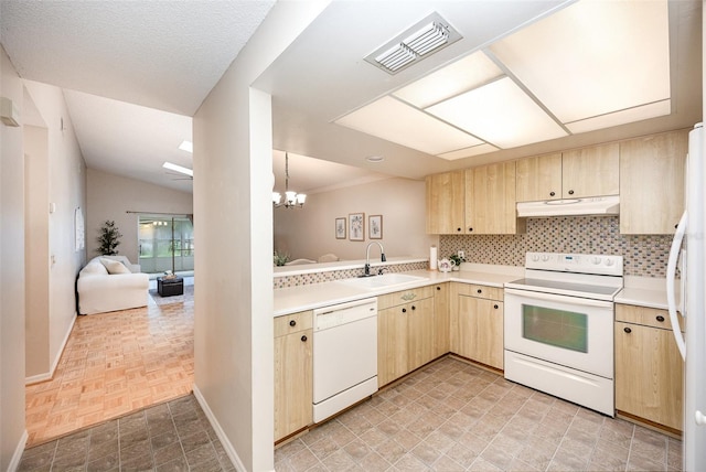 3033 Dunhill Dr, Cocoa, FL 32926 - kitchen with white appliances, under cabinet range hood, light brown cabinets, a sink, and lofted ceiling