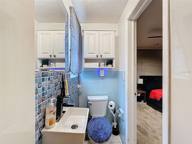 5415 Riddle Rd, Holiday, FL 34690 - half bathroom with toilet and tile walls