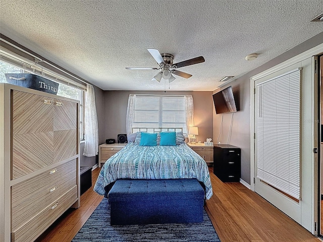 5415 Riddle Rd, Holiday, FL 34690 - bedroom with wood finished floors, a textured ceiling, ceiling fan, and baseboards
