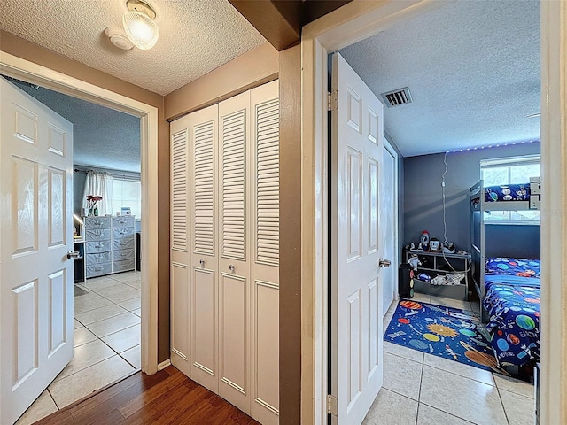 5415 Riddle Rd, Holiday, FL 34690 - hall with a textured ceiling, healthy amount of natural light, and tile patterned flooring