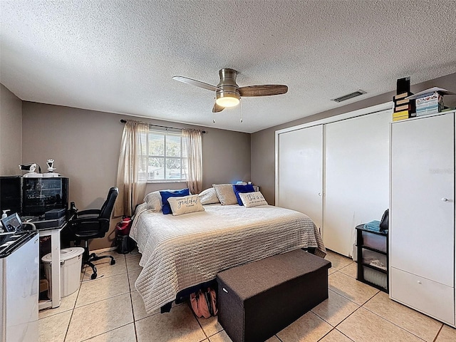 5415 Riddle Rd, Holiday, FL 34690 - bedroom with light tile patterned flooring, a closet, a ceiling fan, a textured ceiling, and a desk