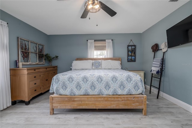 775 Bay Dr, New Smyrna Beach, FL 32168 - bedroom featuring light wood-style floors, baseboards, and ceiling fan