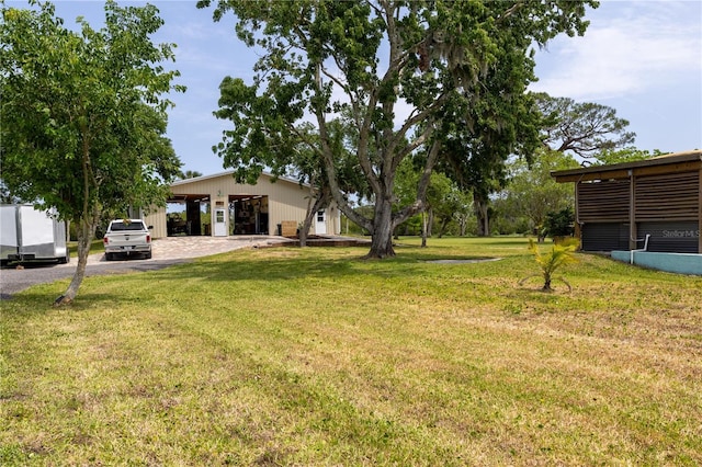 775 Bay Dr, New Smyrna Beach, FL 32168 - view of grassy yard featuring a detached garage
