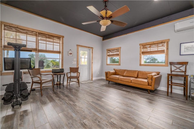 775 Bay Dr, New Smyrna Beach, FL 32168 - living room with a wall unit AC, wood finished floors, baseboards, and ceiling fan