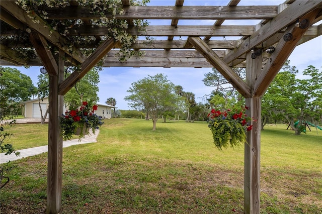 775 Bay Dr, New Smyrna Beach, FL 32168 - view of grassy yard featuring a pergola and an outdoor structure