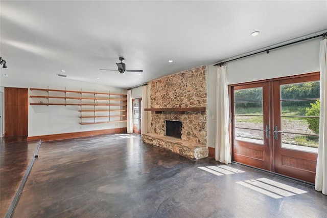 6327 Ridgeberry Dr, Orlando, FL 32819 - unfurnished living room with concrete flooring, french doors, ceiling fan, a fireplace, and recessed lighting