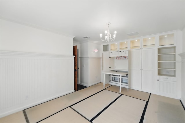 6327 Ridgeberry Dr, Orlando, FL 32819 - unfurnished bedroom with a chandelier and crown molding