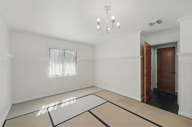 6327 Ridgeberry Dr, Orlando, FL 32819 - unfurnished room with wainscoting, a chandelier, and ornamental molding
