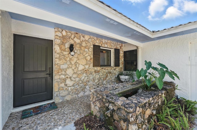 6327 Ridgeberry Dr, Orlando, FL 32819 - entrance to property featuring stone siding and stucco siding