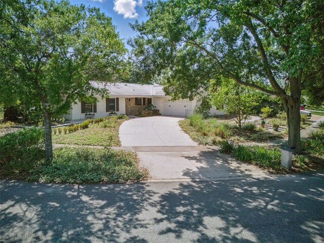6327 Ridgeberry Dr, Orlando, FL 32819 - view of front of house featuring concrete driveway, stucco siding, and a garage