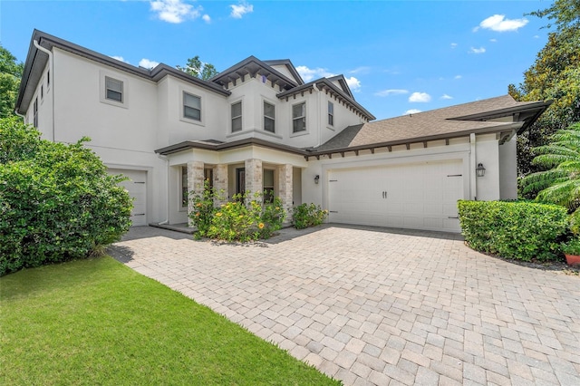 808 Sherbourne Cir, Lake Mary, FL 32746 - view of front of home featuring stucco siding, decorative driveway, a garage, a front yard, and stone siding