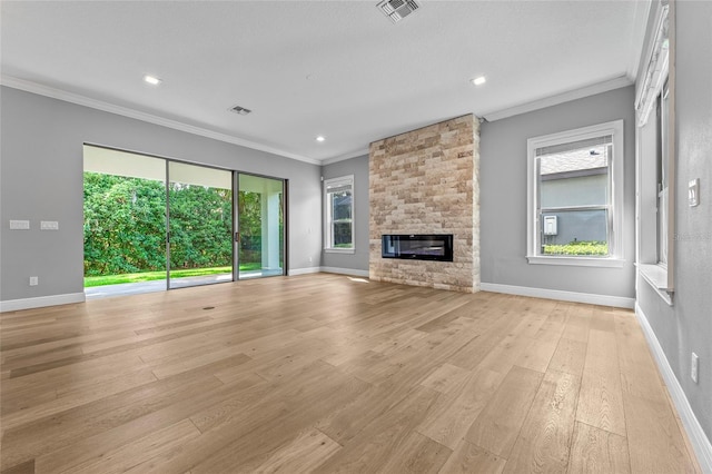 808 Sherbourne Cir, Lake Mary, FL 32746 - unfurnished living room featuring crown molding, healthy amount of natural light, light wood-type flooring, a fireplace, and baseboards