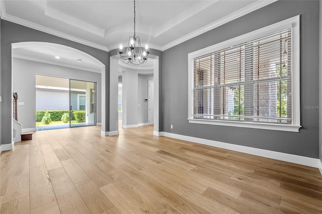 808 Sherbourne Cir, Lake Mary, FL 32746 - unfurnished room with a chandelier, light wood-style flooring, arched walkways, baseboards, and crown molding