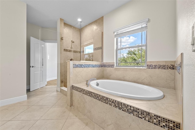 808 Sherbourne Cir, Lake Mary, FL 32746 - bathroom featuring a bath, a walk in shower, tile patterned floors, and baseboards