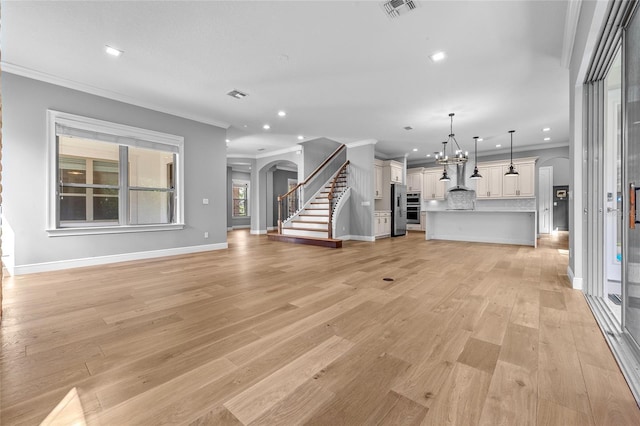 808 Sherbourne Cir, Lake Mary, FL 32746 - unfurnished living room with ornamental molding, recessed lighting, stairway, arched walkways, and light wood-type flooring