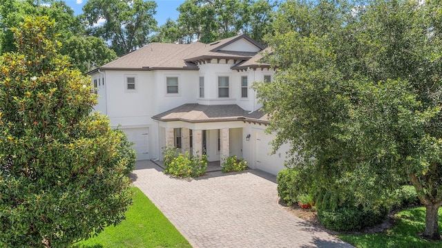 808 Sherbourne Cir, Lake Mary, FL 32746 - view of front of property with a garage, decorative driveway, stucco siding, stone siding, and a shingled roof