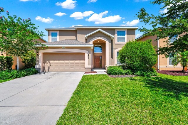 2209 Crofton Ave, Davenport, FL 33837 - traditional-style house with stucco siding, an attached garage, driveway, and a front lawn
