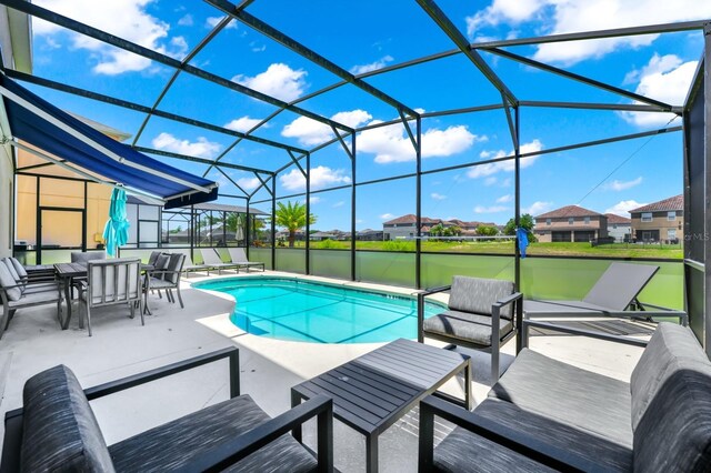 2209 Crofton Ave, Davenport, FL 33837 - swimming pool with a patio, glass enclosure, an outdoor hangout area, and a residential view