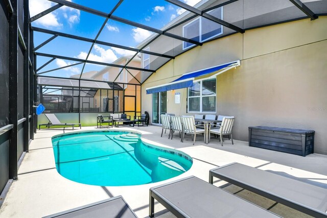 2209 Crofton Ave, Davenport, FL 33837 - outdoor pool featuring a patio area, glass enclosure, and an outdoor living space