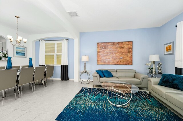 2209 Crofton Ave, Davenport, FL 33837 - living area with arched walkways, a chandelier, and baseboards